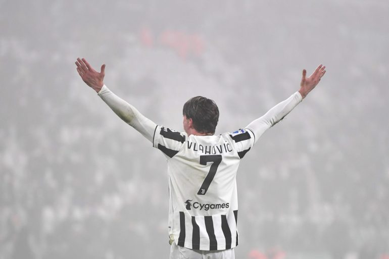 Dusan Vlahovic celebrating after scoring a goal.